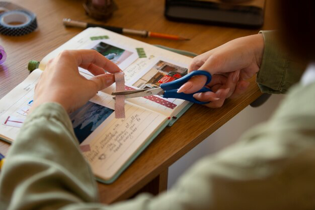 Side view of woman cutting with scissors