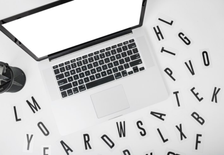 Various Alphabets Around Laptop