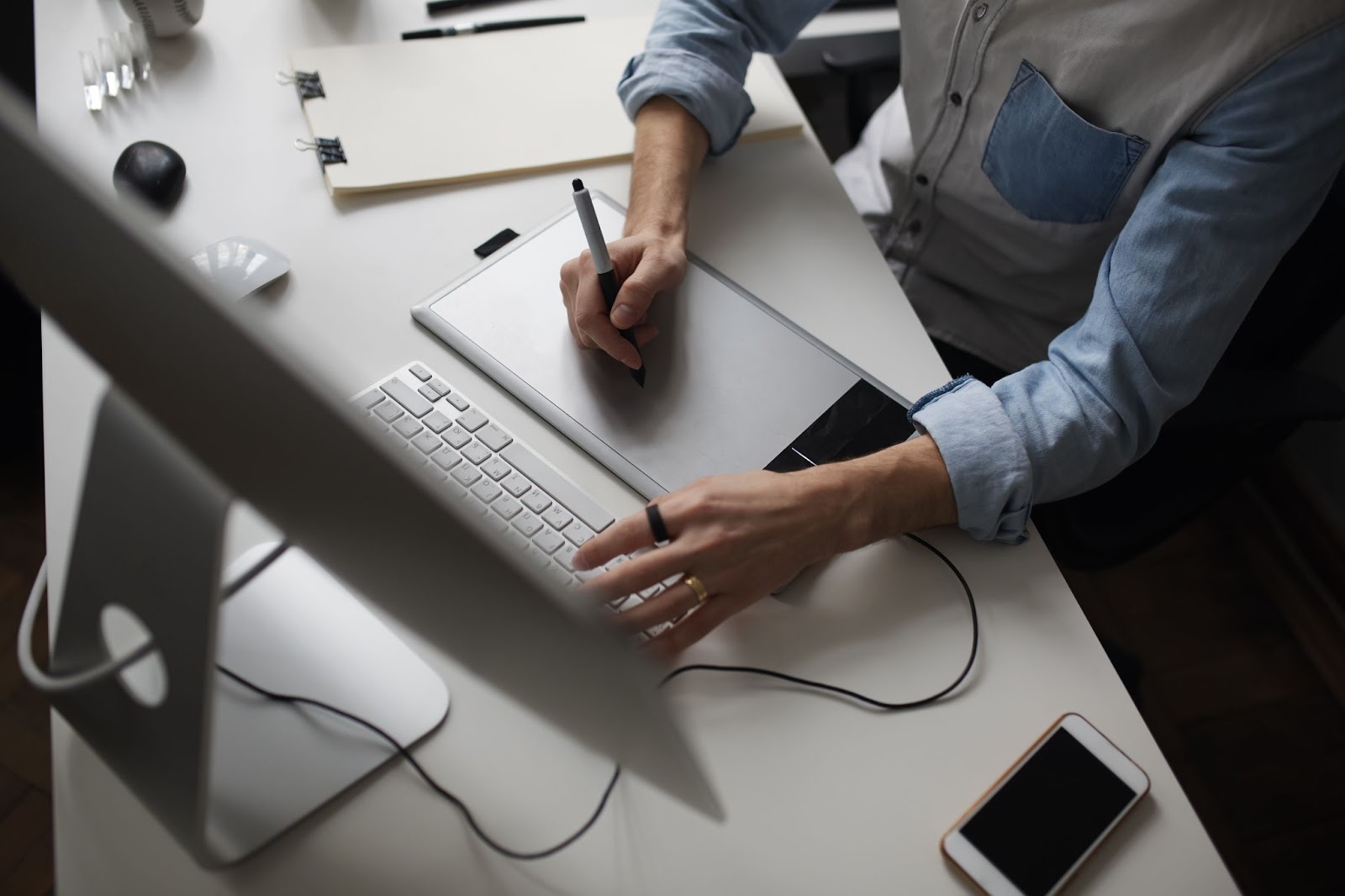 Male designer using graphics tablet while working with computer