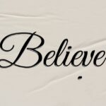 calligraphy letter writing: the word “Believe” written on paper