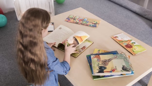 Girl with books on the table