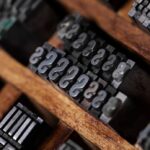 Rows of metal typeset letters in a printing tray