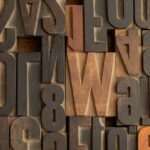 Various wooden letterpress blocks with letters and numbers in a close-up view