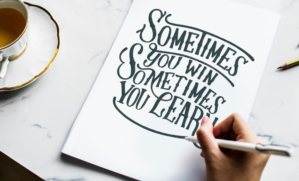 an artist creating hand lettering artwork