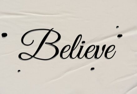 calligraphy letter writing: the word “Believe” written on paper